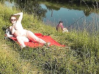Wild beach. Sexy MILF Platinum naked sunbathing on river bank, random fisherman guy watches. Naked in public. Nude beach