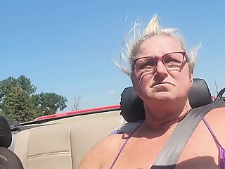 Tits out while riding in a convertible 