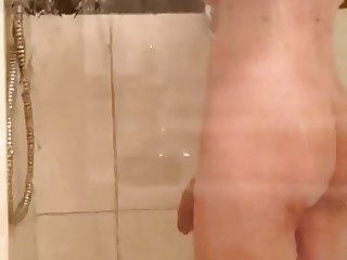 Enormous Cock dangling through the shower door
