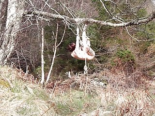 Naked self-bondage in the woods gone wrong.