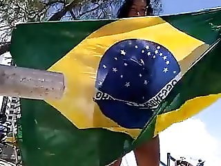 Crazy Dinha dancing with Brazil's flag