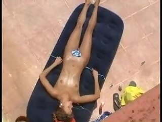 Girl caught sunbathing topless