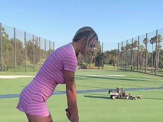 Blonde lady golfer practices really hard