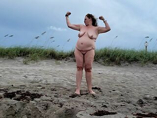 Mature BBW being silly and walking on nude beach.