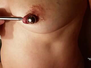 nippleringlover horny milf inserting 16mm metal beads in extreme stretched nipple piercings