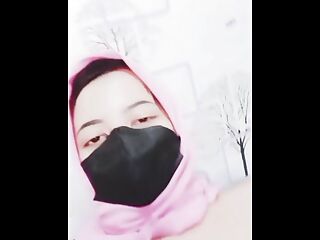 hijab woman playing with dildo in room