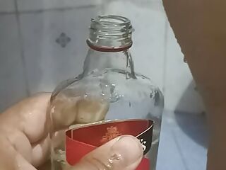 Bhabi pissing in rum bottle 