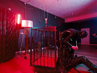 Rubber Nights: the Rubber Slave Rests Tight in a Cage Under the Bed