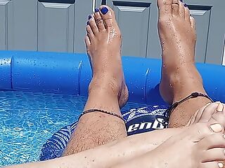 Showing off our pedicured toes in the back yard pool