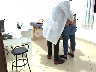 Proctologist performs anal exam on constipated patient.